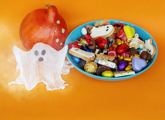 ghost  candy bowl of cookies, candy, chocolates and sweets, Halloween Jack o Lantern - Trick or Treat Halloween card orange background