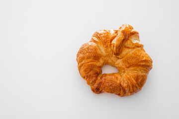Croissant with glacing against white background