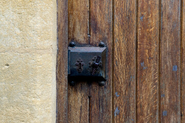 Old wooden door entrance with an antique door handle and lock