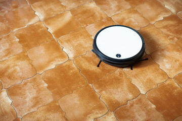 Modern robot vacuum cleaner performs automatic cleaning. Smart home. Automated vacuum cleaning...