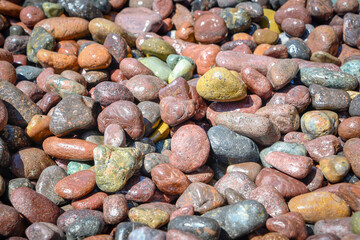 Multicolored pebbles. Colors of the wild nature on a beach. Corsica.