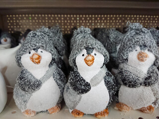 Figures on the New Year theme. Many penguin figures in warm gray hats