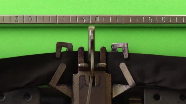 Typing on retro typewriter on a green page. Chromakey.