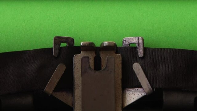 Typing on retro typewriter on a green page. Chromakey.