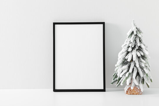 Christmas holiday composition. Xmas tree, photo frame, decoration on white background. Christmas, New Year, winter concept. Front view, copy space