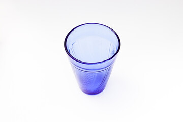 Empty blue water glass Isolated on white background.