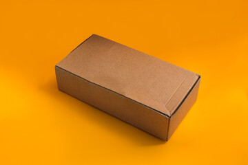 Brown Cardboard box isolated on orange background