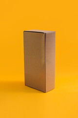 Brown Cardboard box isolated on orange background