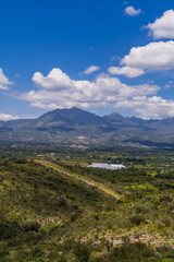 Vertical view landscapes of Hidalgo, Mexico with cactus, green plains,  and mountains near Tasquillo
