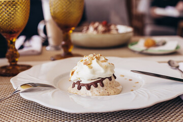 Sweet dessert, cupcake and ice cream on white plate, on restaurant background