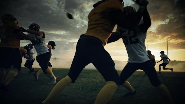 American Football Field Two Teams Play: Successful Player Running to Score Touchdown Points. Professional Athletes Compete for the Ball, Tackle, Fight for Victory. Dramatic Golden Hour, Slow Motion