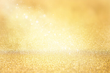 Golden glitter background. Abstract background with bokeh and defocused lights. Christmas holiday background