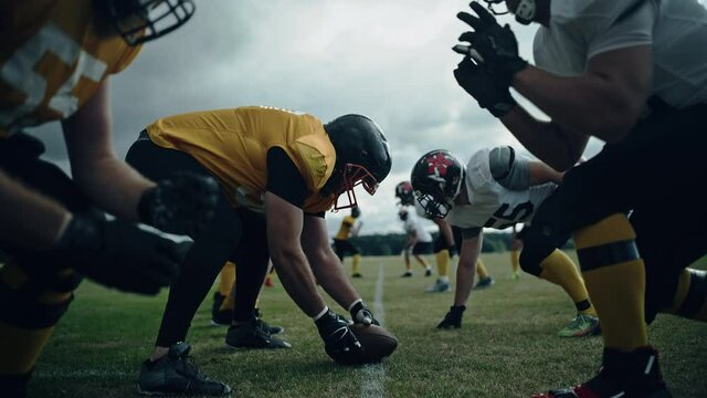 American Football Teams Start Game: Professional Players, Aggressive Face-off, Tackle, Pass, Fight for Ball and Score. Competition Full of Brutal Energy, Power, Skill. Cinematic Handheld Shot