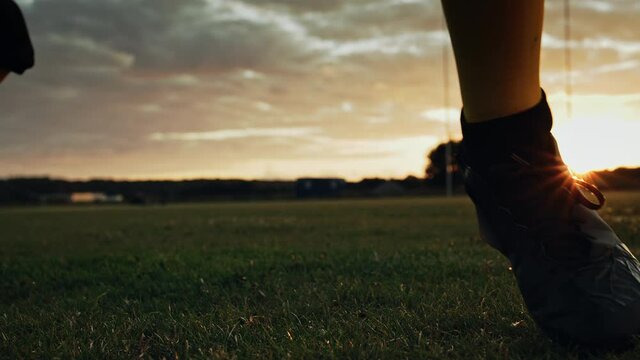 Cinematic American Football Kickoff Game Start. Static Close-up of Ball Being Kicked by the Professional Player. Gates Goal Kick. Successful Team Wins Championship. Stylish Slow Motion Shot