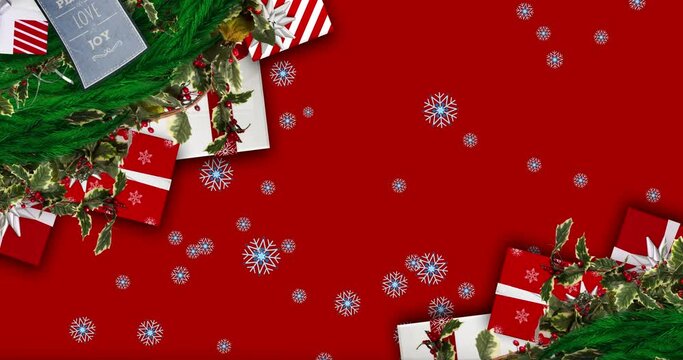 Snowflakes falling over christmas wreath decoration and gifts against red background