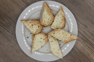 Overhead view of perfect appetizer for a hearty Italian meal starts with cheesy garlic knots bread