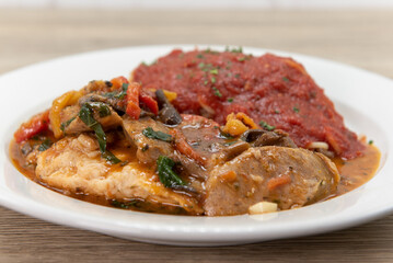 Double chicken breast served with spaghetti with marinara sauce as pollo campagnola