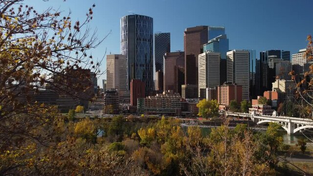 Calgary Alberta Canada, October 1 2021: Aerial of trees in autumn colours facing a downtown Canadian city.