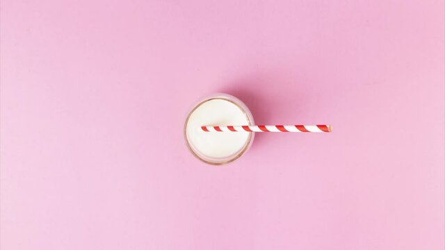 christmas stop motion of a plate with cookies turning into a glass of milk and wrapped in craft paper gift, treats for santa claus, flat lay, top view