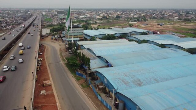 Lagos-Ibadan Expressway connecting Ogun State to Lagos State. This is Kara Bridge by Ojodu Berger and The famous big Nigeria Flagged Chineese Industry.