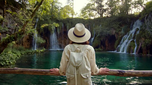 Young woman looking at waterfalls in Croatia
