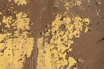 Old wall painted with lackluster colors that is chipped or peeling due to the passage of time and no maintenance. Colorful textured background