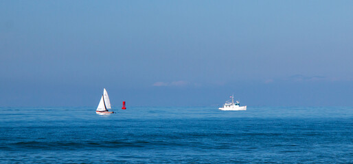 Sailboat and fishing boat in the Pacific Ocean near Ventura California United States