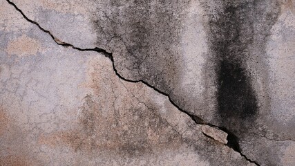 The old cement wall was weathered, the surface was scratched, the surface was scratched and damaged. For a mysterious retro-conservative background.