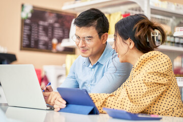 Owner of business male working with partner for business plan by laptop