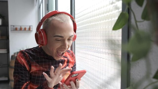 young non binary model using smartphone and scrolling the screen for social networks