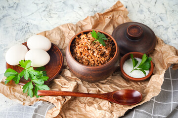 Protein rich food, healthy breakfast, healthy food concept, diet. Buckwheat porridge in a pot, boiled eggs.