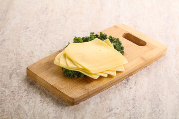 Sliced Gouda cheese over board