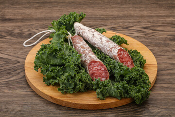 Spanish Fuet sausage with salad leaves