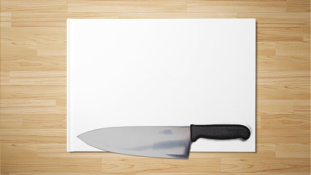 Sharp knife on white paper on wooden background stock with copy space free image photograph