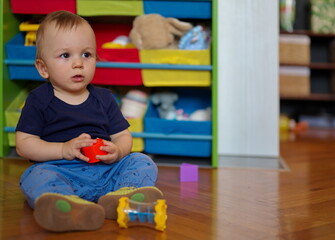 Adorable little baby playing on the floor