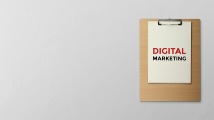 Digital marketing is written on a clipboard flat lay on the table with copy space