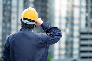 Asian maintenance worker man wearing protective suit and safety helmet working at construction...