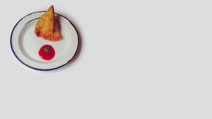 Samosa Indian dish with red sauce