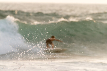 surfer rides a wave for splashes