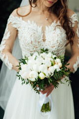 Obraz na płótnie Canvas Beautiful wedding bouquet of flowers in hands of the bride