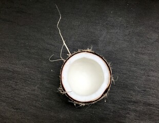 open coconut with pulp on gray background