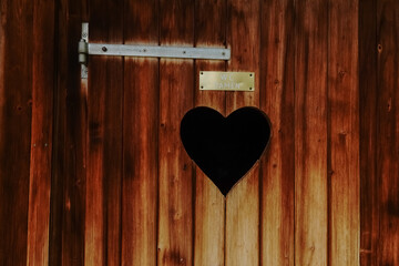 heart in a wooden toilette for women while hiking in austria