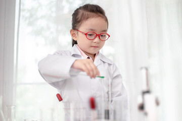 scientist girl with liquid solution in a laboratory	
