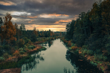 Sunset over the river in autumn