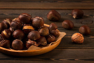 Roasted chestnut, on a wooden table, no people,