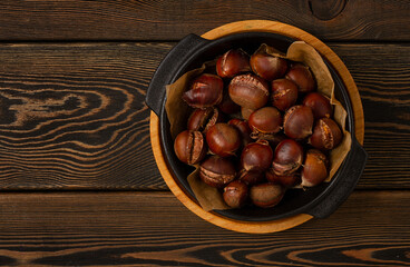 Roasted chestnut, on a wooden table, no people,