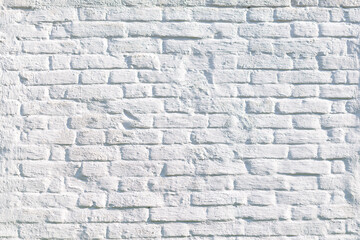 red brick wall covered with whitewash