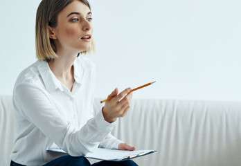 Business woman sitting on sofa work documents office