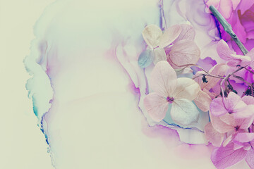 Creative image of pastel blue and purple Hydrangea flowers on artistic ink background. Top view with copy space
