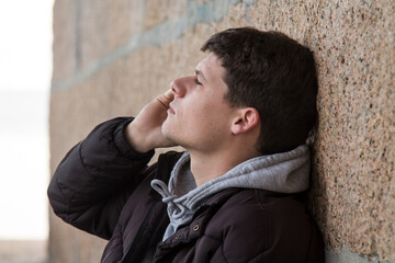 young man in jacket and phone with headphones